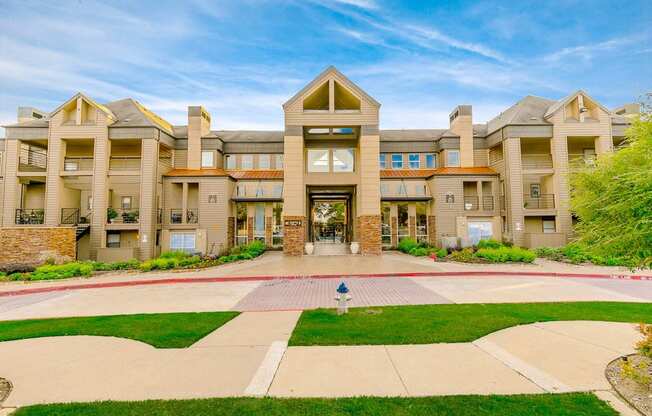 a large building with a lawn in front of it