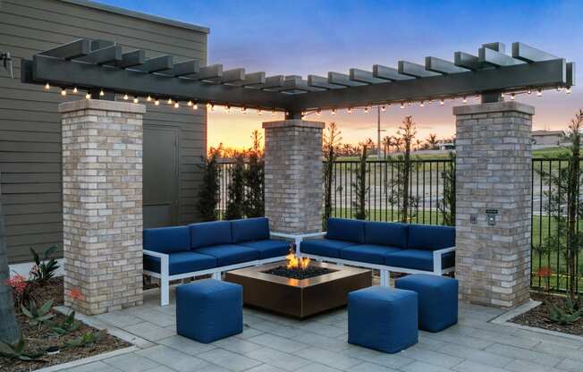 a patio with blue couches and a fire pitat Westbury Apartments, Rancho Cucamonga, California 