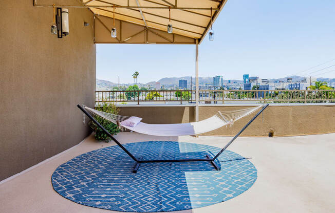 a hammock on a balcony with a view of the city