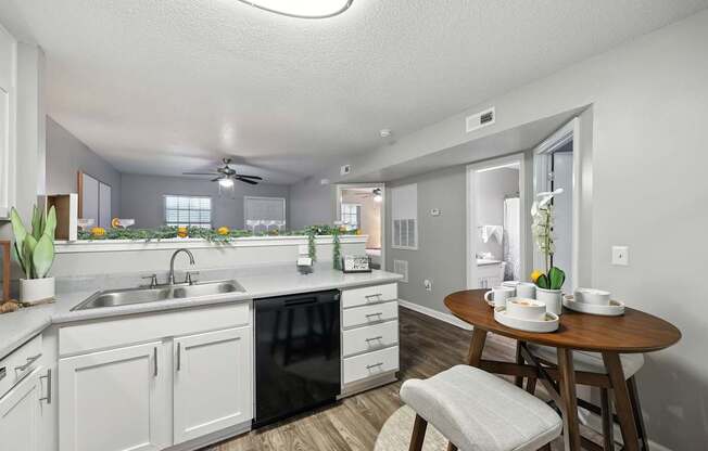 A kitchen with a dining table and chairs.