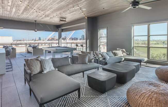 a living room with couches and a table and a view of a bridge
