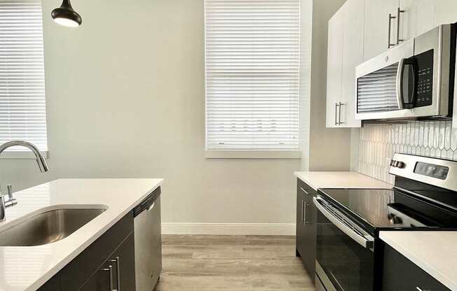 A modern kitchen with dark wood cabinets and a white countertop.