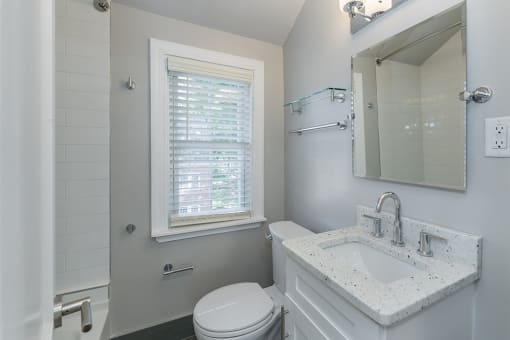 The Cary bathroom with granite vanity countertop and tile shower/tub