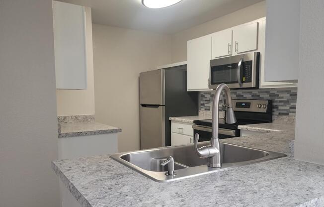 a kitchen with a sink and a mirror