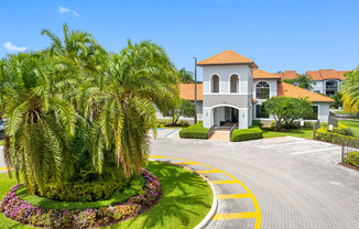 A large house with a red roof and a driveway with a yellow line.
