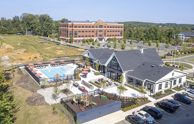 an aerial view of a resort with a swimming pool and a building