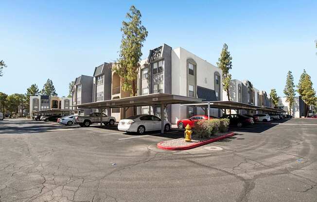 A parking lot with a fire hydrant and a building in the background.
