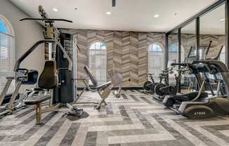 an image of a gym with exercise equipment on the floor