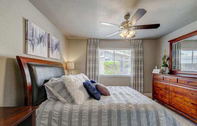 a bedroom with a large bed and a ceiling fan