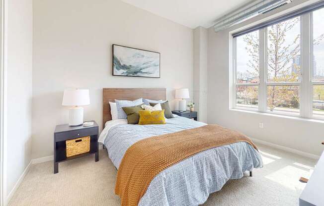 a bedroom with a large window and a large bed