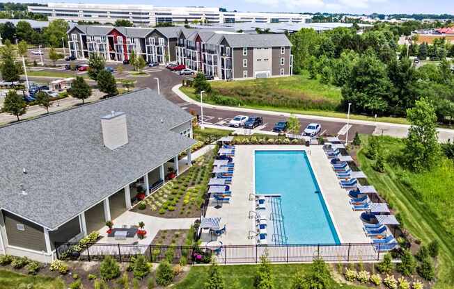 A large building with a pool in front of it.