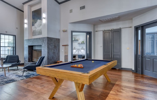 a pool table in the clubhouse at the bradley braddock road station apartments