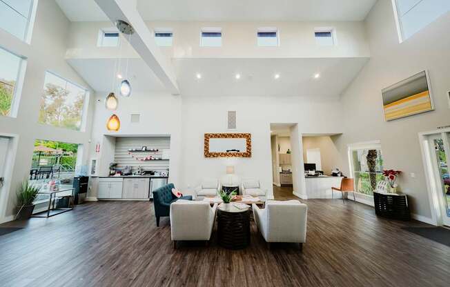 A large open living room with a dining area and kitchen in the background.