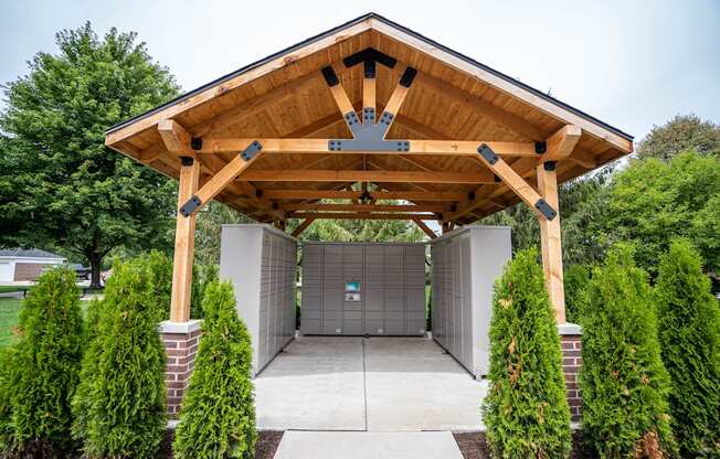 A wooden covered walkway leads to a garage.