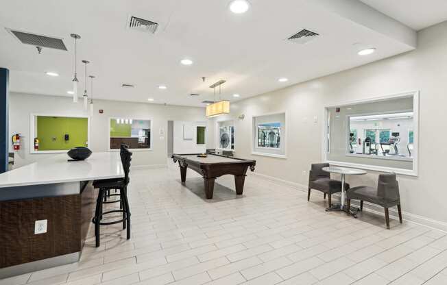 a game room with a pool table and a bar