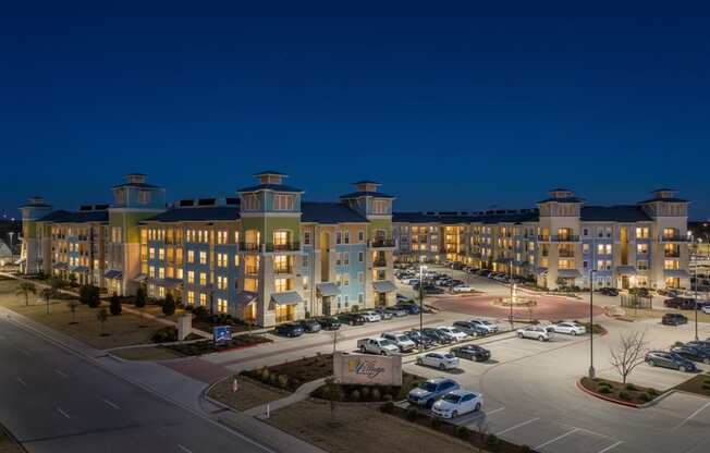A large building with a parking lot in front of it.
