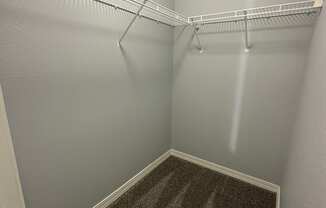 a small empty room with a wire rack hanging on the wall