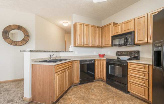 Interiors-Large kitchen with black appliances at Stone Ridge Estates townhomes in South Lincoln