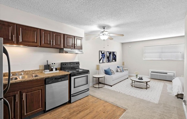 a kitchen and living room with a ceiling fan