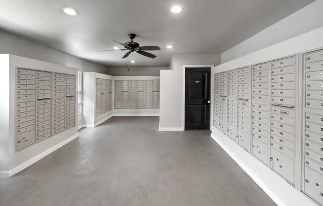 a locker room with lockers and a ceiling fan