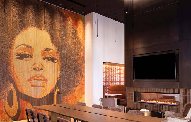 a conference room with a large painting of a woman on the wall