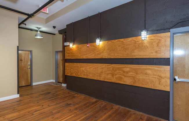 a large room with wood floors and a wooden wall at Mayton Transfer Lofts, Virginia