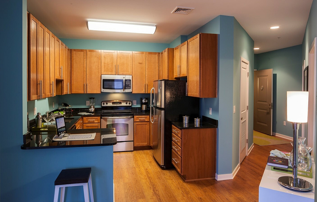 Contemporary Kitchen With Granite Countertops, Wood Cabinets & Stainless Steel Appliances