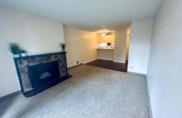 a living room with a fireplace and a carpet