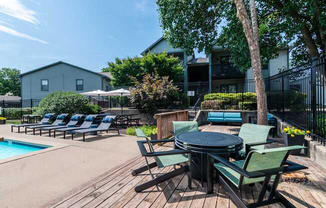 Poolside area with table and chairs at Springhill Apartments, Overland Park, 66213