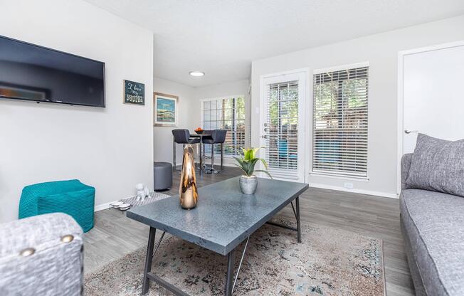 a living room filled with furniture and a large window