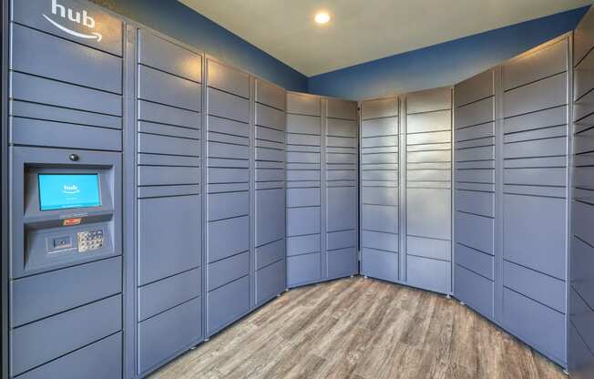 a bunch of blue lockers in a room with a coin machine