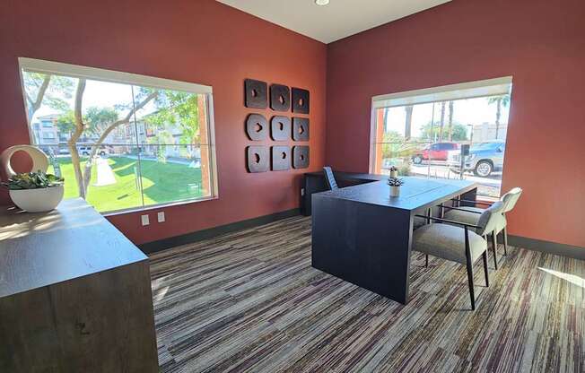 A room with a table and chairs and a view of the outside.