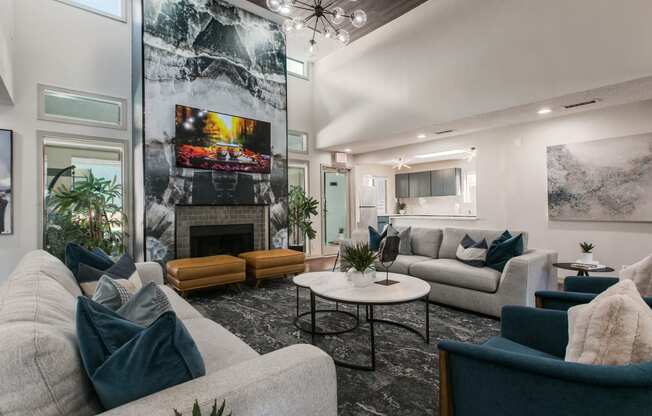 a living room with couches and chairs and a fireplace