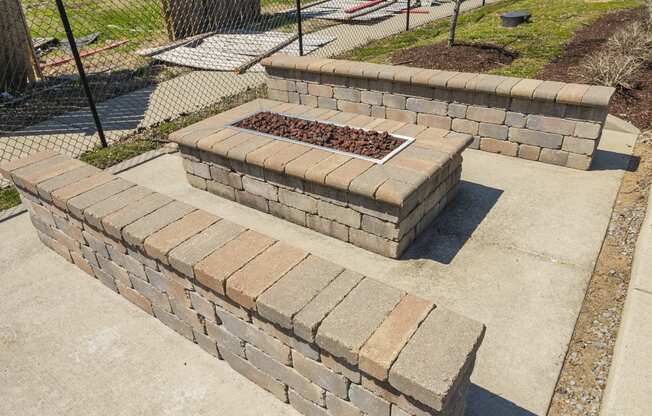 a retaining wall with a fire pit in the middle of it