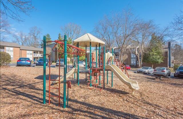 a playground with a slide in a park