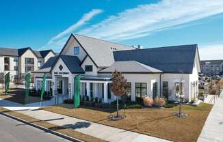 a white house with a gray roof and a sidewalk at The Fitzroy San Marcos, San Marcos