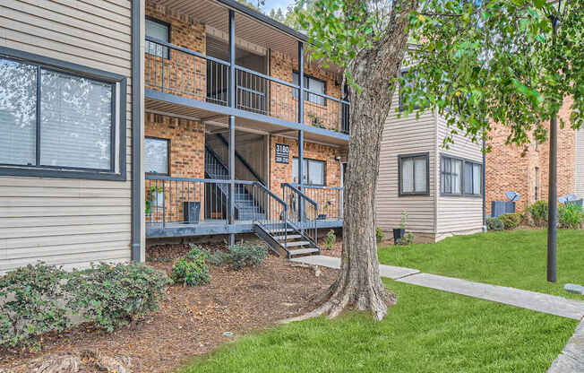 A tree is in front of a building.