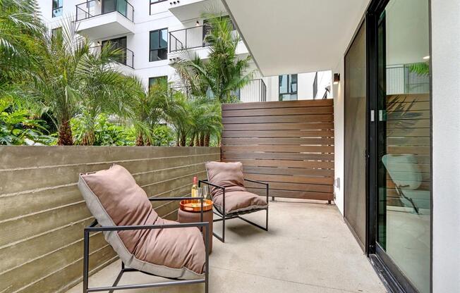 a balcony or terrace with two chairs and a table