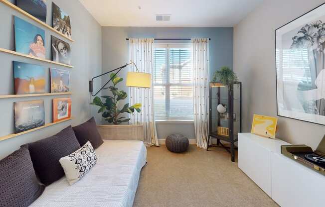a living room with a couch and a window at The Bend Arbordale, Williamsburg, VA