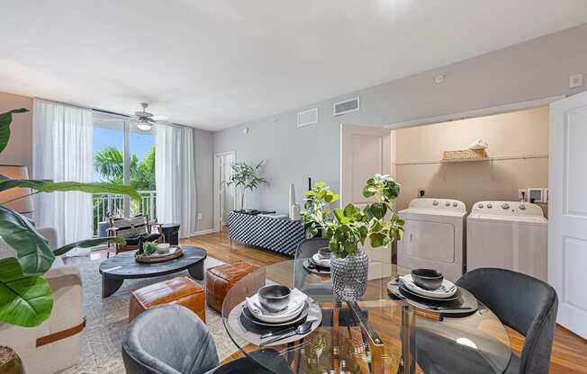 a kitchen and living room with a table and chairs