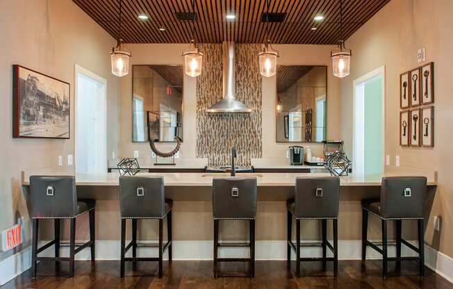 a kitchen with a long island with four stools in front of it