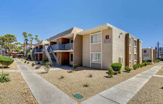 A row of houses with a clear blue sky above them.