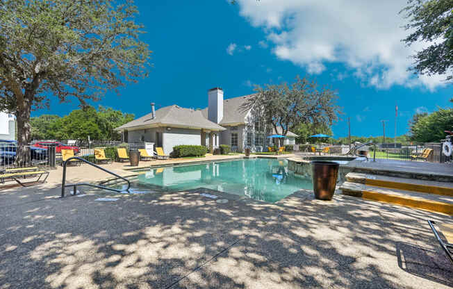 a resort style pool with a building in the background