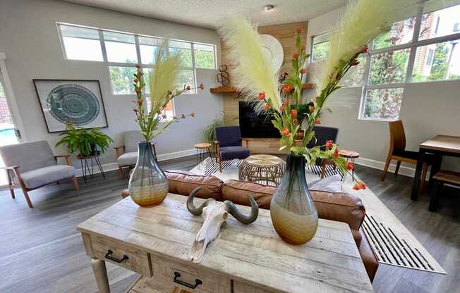 A rustic wooden table with two vases on it.