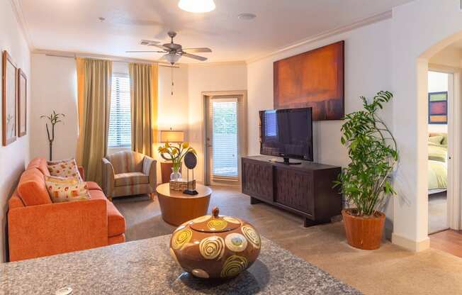 a living room filled with furniture and a flat screen tv