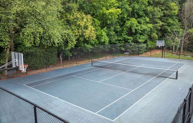 a tennis court with a basketball court on top of it