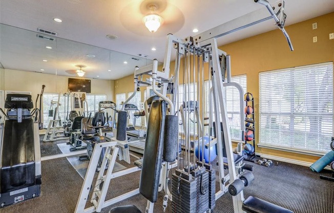 Fitness center Gym at Trinity Square Apartments in North Dallas, TX, For Rent. Now leasing 1 and 2 bedroom apartments.