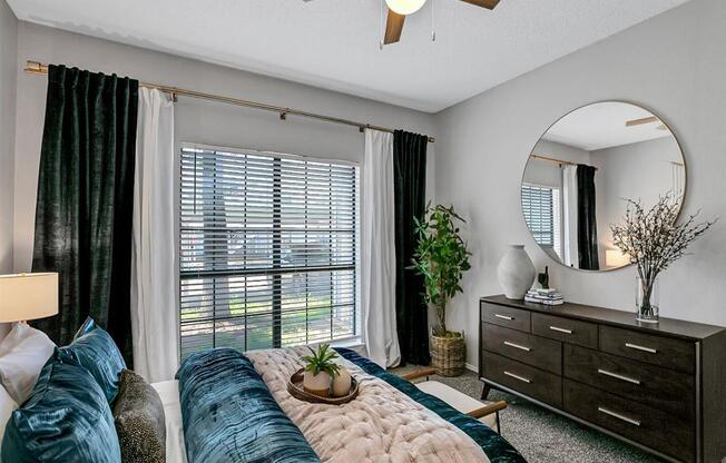 a bedroom with a bed and a ceiling fan