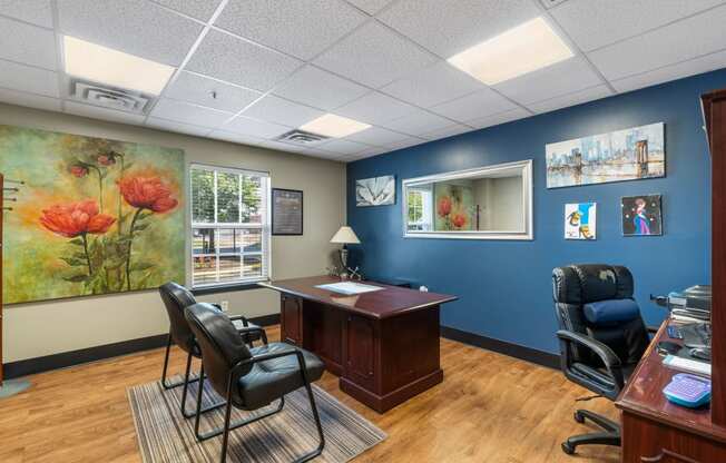 a business office with blue walls and a wood floor