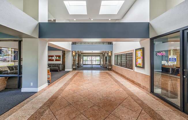 a large hallway with tile floors and a large skylight